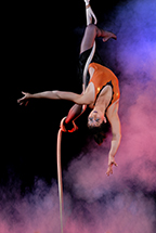 Female Performer hanging upside down from rope